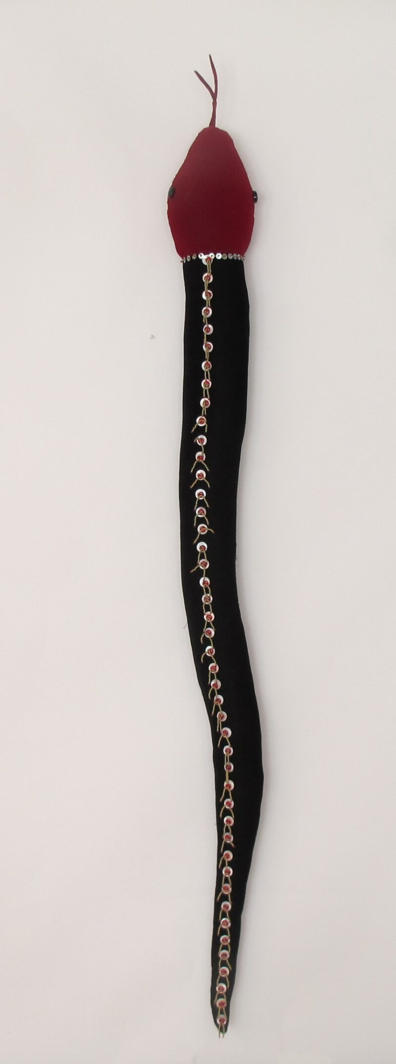 Name: Button Snake Soft Sculpture Materials: Velvet, Buttons, Beads Size: 52H x 7W Year: 2022